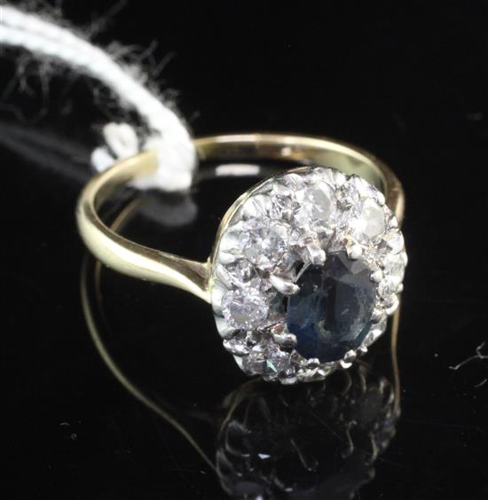 An 18ct gold and platinum, sapphire and diamond cluster ring, size O.